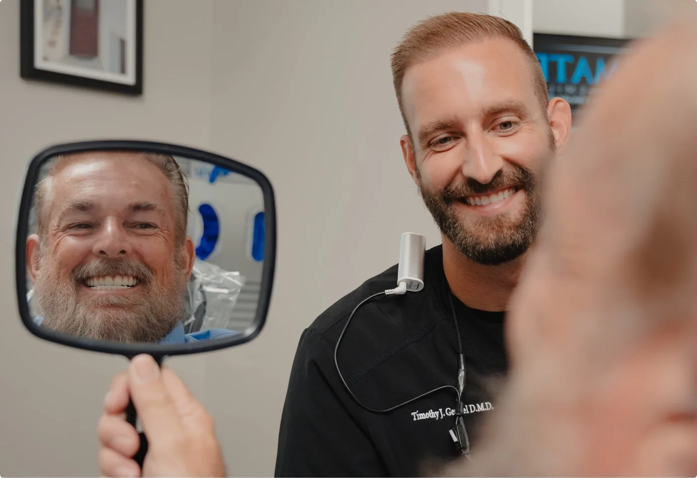 Patient with new smile showing assistant the result